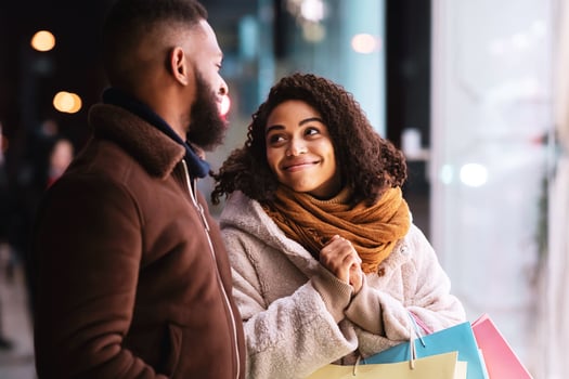 Please, Buy Me This. Excited emotional african american woman walking with her man near shopping mall in the evening, asking gift and present. Seasonal Sales, Discount, Holiday, Retail And Purchase photo