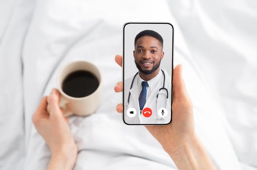 Woman Having Call With Doctor Lying In Bed At Home. Online Medical Consultation Concept. Virtual Clinic Helpline And Mobile Healthcare App. Physician Consulting Patient Distantly. Cropped photo