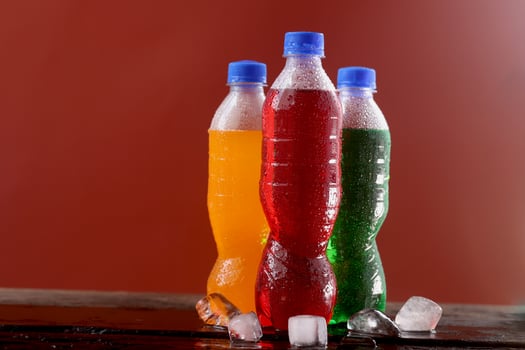 Soft drink bottle red background photo