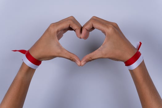 Hand Fist Holding a Red and White Ribbon, Indonesian Independence Day Concept Love Gesture photo