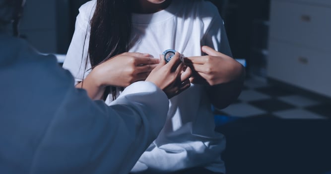A woman is getting her heart checked by a doctor photo
