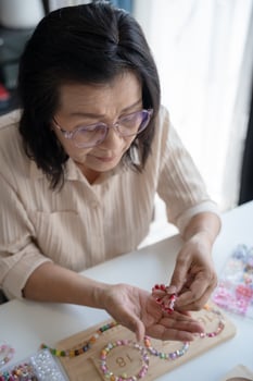 Senior mature older asian woman Art hobby handmade beads jewellery accessories handcraft photo