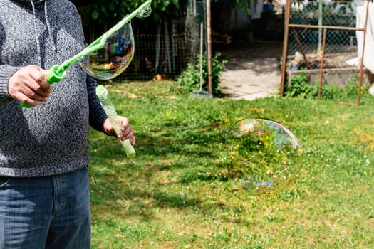 Soap bubble, outdoors activity and leisure for happy kid, real life photo, summertime photo