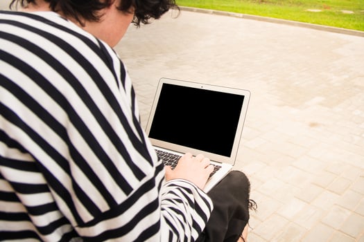 Freelancer focused on laptop while outdoors photo