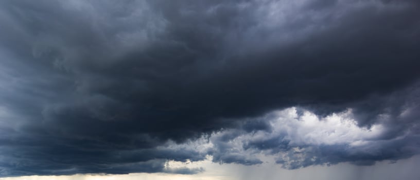 dark sky with heavy clouds converging and a violent storm before the rain.Bad or moody weather sky and environment. carbon dioxide emissions, greenhouse effect, global warming, climate change. photo