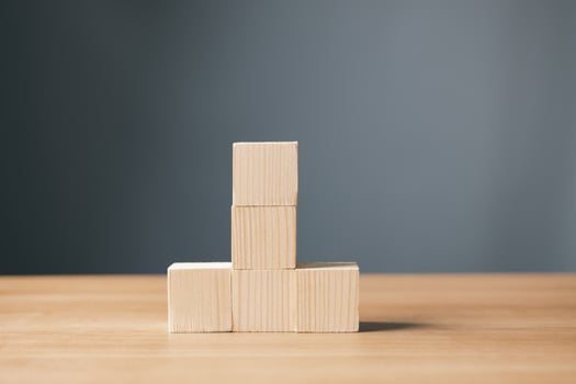 wood empty five blocks stack on table and gray background with copy space for text or symbols, development concept for growth success process. photo