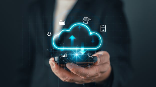 A businessman holds a smartphone with a glowing cloud icon, symbolizing cloud computing, data storage, digital solutions, and online technology for modern business and virtual connectivity photo