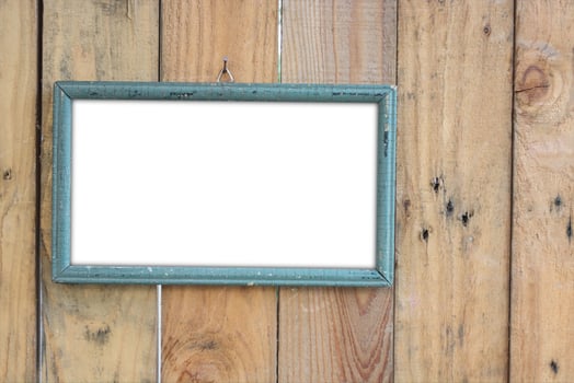 old vintage wooden photo frame on old wooden wall.