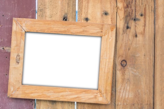 old vintage wooden photo frame on vintage wooden board.