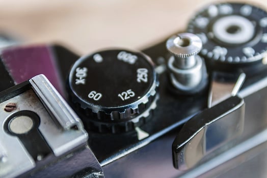 Old film camera, The wheel of choice shutter and shutter button, Close up view at 125 speed shutter, Selective focus, Vintage photo style