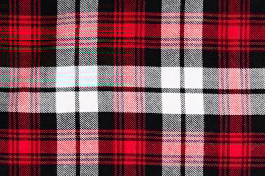 background in a cage white with red and black fabric close-up photo