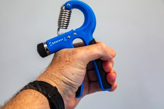Blue hand grippers for strength training and exercise portrait photo