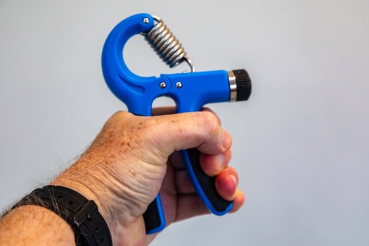Blue hand grippers for strength training and exercise photo