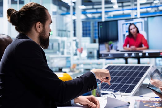 Photovoltaics factory team in teleconference meeting improving development efficiency. Solar panels plant researchers in office studying how to harness sun power during online videocall photo