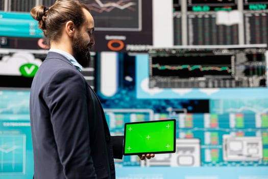 Male expert uses tablet with chroma key display leveraging dashboards, financial trends and KPI metrics optimizing company performance and planning for future success. Leadership. photo