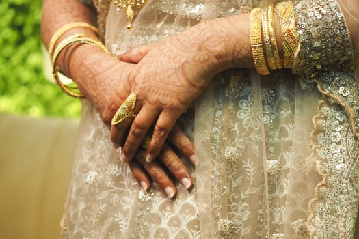 Hands decorated with henna and gold jewelry showcase cultural elegance photo