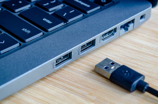 USB plugged into high speed port symbolizing convenience and cyber risk trade off photo