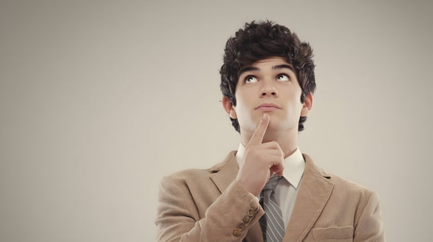 Young Man in Beige Corduroy Jacket Thinking Contemplative Expression photo