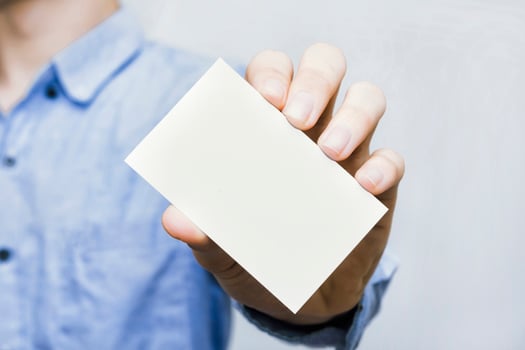 Close up of a businessman holding a clean business card mockup. Perfect for personal branding, corporate exchange, contact sharing, and modern marketing concepts. photo