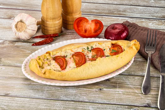 A plate with a pizza on it and a knife and fork photo
