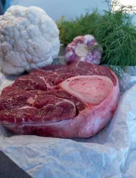 Raw Beef Shank with Bone and Fresh Vegetables on Parchment photo