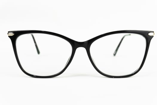 Black-framed eyeglasses on a white background, suitable for themes related to vision, fashion, or education. photo