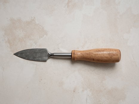 Cheese Knife with Wooden Handle on Rustic Background, Sharp Blade, Stainless Steel. photo