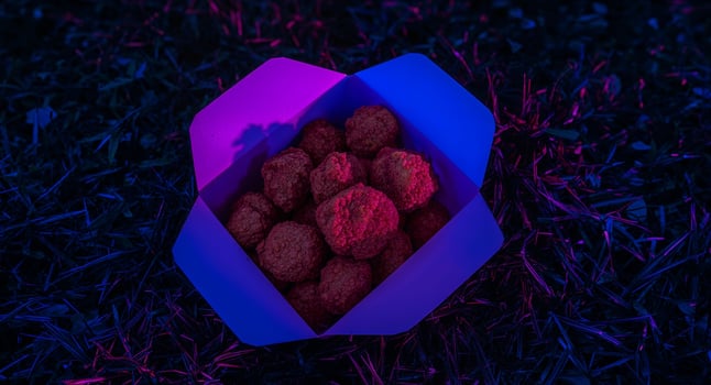 Delicious Meatballs in a Takeout Box. A Vibrant Nighttime Feast on the Grass. photo