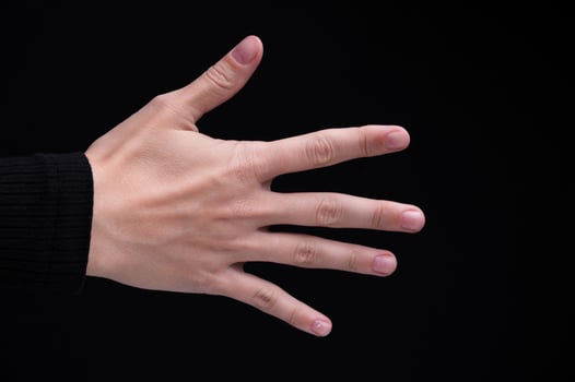 Caucasian woman's female hand back side on black background photo