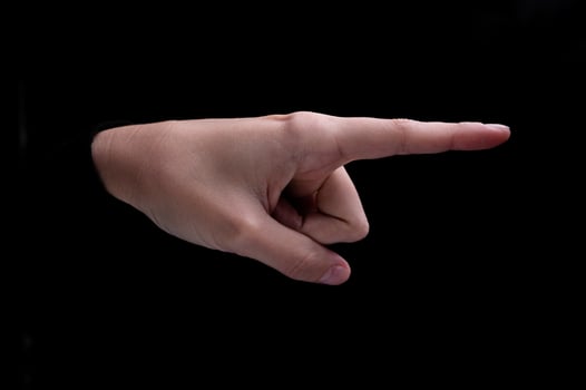 Female hand of caucasian woman pointing fingers to the right side on black background photo