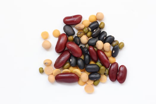 a pile of beans and other legumes on a white background photo