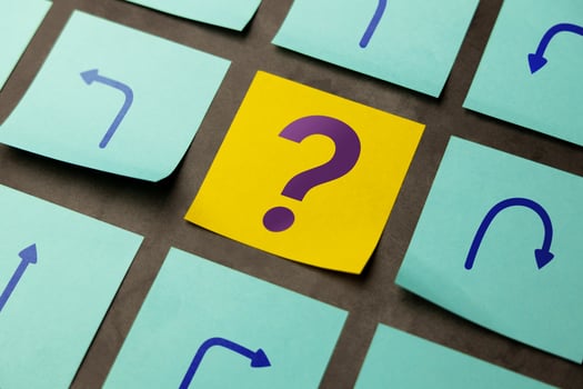 Economic uncertainty symbolized by arrows and a question mark, reflecting volatility and lack of clear direction photo