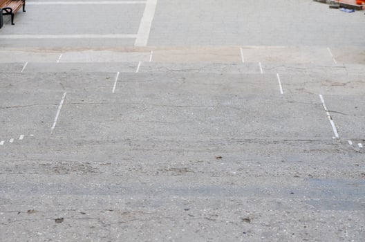 A grey concrete sidewalk with a white line painted down the middle. The sidewalk is empty and has no people or objects on itv photo