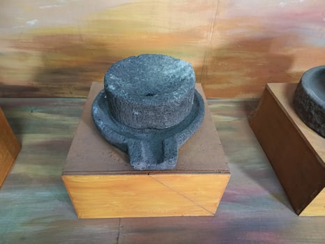 Stone Mill Grinder Ancient Tool Artifact on Wooden Stand photo