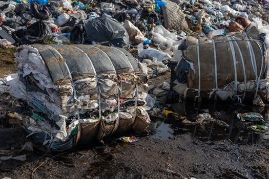 A landfill site overflowing with bundled trash reveals the severe impact of pollution and challenges in effective waste disposal and recycling photo
