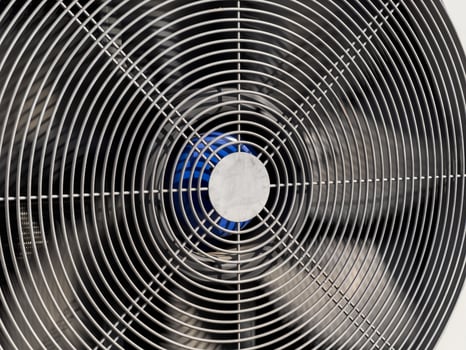 A detailed perspective of a metal fan, showcasing its spiral blades and center, designed for efficient airflow in a warm environment photo