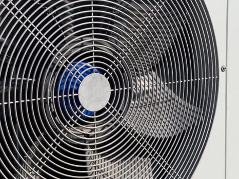 An industrial fan is set up outdoors, efficiently circulating air in a warm environment, ensuring comfort and cooling photo