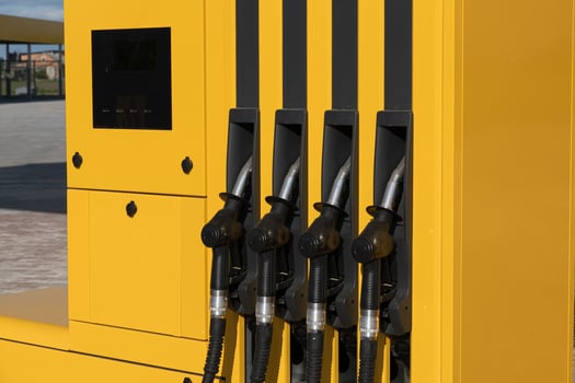 Four fuel nozzles are visible at a gas station's fuel dispenser, ready for customers to fill their vehicles with gasoline photo