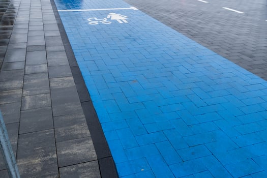 A designated accessible parking area is indicated with blue pavement and clear symbols, emphasizing inclusivity in urban design photo