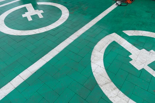 Clear markings on a green parking area illustrate designated spots for electric vehicles and bicycles, promoting eco-friendly transport options photo