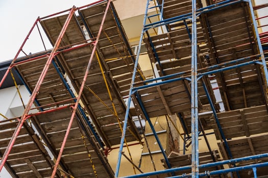 Workers rely on sturdy scaffolding to safely navigate and complete building projects at a construction site in progress photo