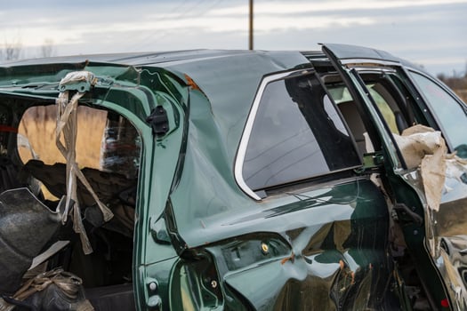 A damaged car sits at an accident site, showcasing the destructive impact of crashes on transportation safety and the importance of insurance photo