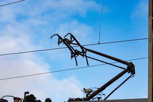 Electric train overhead lines stretch across the sky, showcasing modern transportation technology in a railway station setting photo