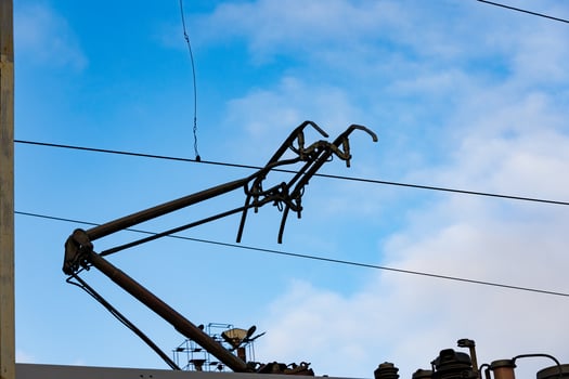 Overhead lines for electric trains stretch against a bright blue sky, showing modern transportation infrastructure at a railway station photo