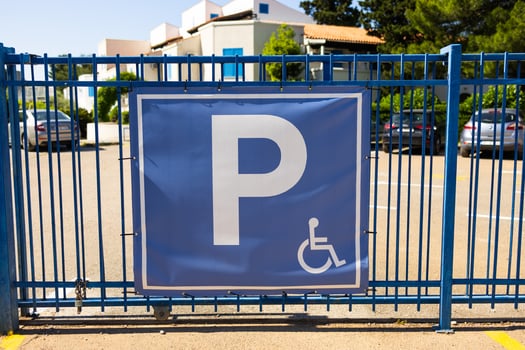 Parking sign on blue gate. Urban accessibility, transportation regulation, and inclusive infrastructure in public spaces photo