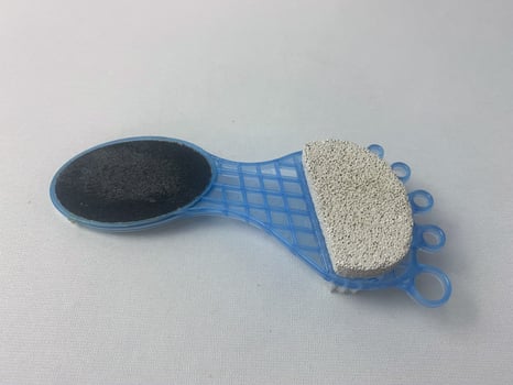 Foot care tool with pumice stone and file for exfoliation and smoothing skin photo