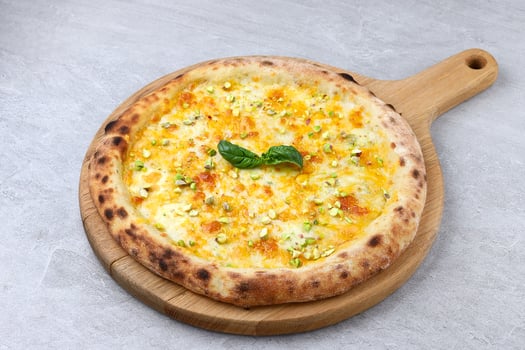 Wood-Fired White Pizza with Melted Cheese, Pistachios, and Fresh Basil photo