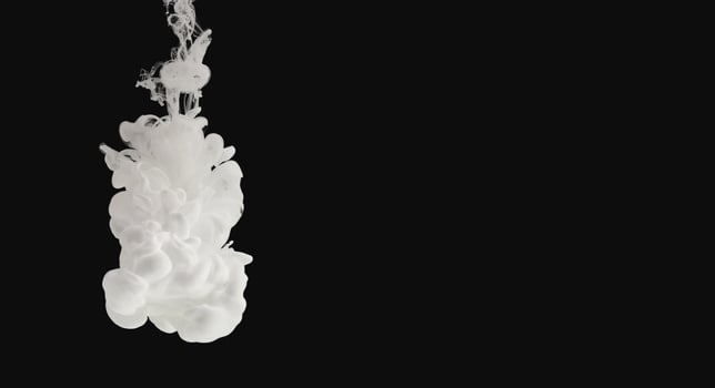 White paint flowing in water isolated on black background, panorama with free space photo