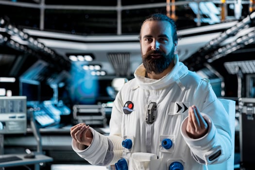 Astronaut does explanation in starship during videocall with command center on Earth. Orbit station crew member talks with researchers, doing mission update during communication link to ground control photo