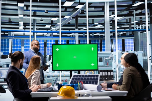 Solar panels plant manager uses green screen monitor to present manufacturing strategies to investors. Photovoltaics factory executive uses mockup display to show data to shareholders photo